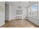 Bright dining room with hardwood floors, a chandelier, and natural light from the large window at 7628 Winners Edge St, Raleigh, NC 27617