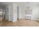 A bright dining room with hardwood floors, a chandelier, and natural light from the window at 7628 Winners Edge St, Raleigh, NC 27617