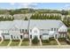 A beautiful front exterior view of townhomes, showcasing well-maintained landscaping at 7628 Winners Edge St, Raleigh, NC 27617