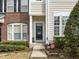 Inviting front entrance with classic black door and landscaped shrubbery at 7628 Winners Edge St, Raleigh, NC 27617