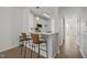 Kitchen counter with bar stool seating, view to the kitchen and living room at 7628 Winners Edge St, Raleigh, NC 27617