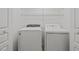 Washer and dryer in the upstairs laundry room with shelving at 7628 Winners Edge St, Raleigh, NC 27617