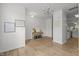 A bright living room with hardwood floors with an entry to the kitchen at 7628 Winners Edge St, Raleigh, NC 27617