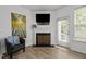 Bright living room featuring a fireplace and door leading to the outside at 7628 Winners Edge St, Raleigh, NC 27617