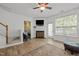 Bright living room features a fireplace, ceiling fan, and door leading to the outside at 7628 Winners Edge St, Raleigh, NC 27617