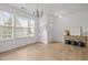 A bright living room with hardwood floors and natural light from the large windows at 7628 Winners Edge St, Raleigh, NC 27617