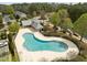 Aerial view of the community pool surrounded by trees and townhomes at 7628 Winners Edge St, Raleigh, NC 27617