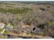 Aerial view showcasing the homes location nestled amongst lush greenery and neighboring residences at 765 Carlton St, Clayton, NC 27520