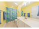 Bright bathroom featuring a vanity, large mirror, and colorful shower curtain at 765 Carlton St, Clayton, NC 27520