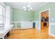 Bright dining room featuring wainscoting, hardwood floors, and a chandelier at 765 Carlton St, Clayton, NC 27520