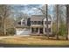 Charming two-story home with a two-car garage, dark shutters, and manicured landscaping at 765 Carlton St, Clayton, NC 27520