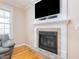 Living room with hardwood floors featuring a stone fireplace and television at 765 Carlton St, Clayton, NC 27520