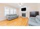 Comfortable living room with a fireplace, large windows, ceiling fan and hardwood flooring at 765 Carlton St, Clayton, NC 27520