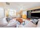 Large living room with hardwood floors, built-in shelving, and a ceiling fan at 765 Carlton St, Clayton, NC 27520