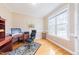 Well-lit office space with a large window, hardwood floors, and neutral colored walls at 765 Carlton St, Clayton, NC 27520