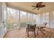 Relaxing screened porch with a ceiling fan, wood floors and a view of the trees at 765 Carlton St, Clayton, NC 27520