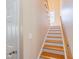 Light-filled staircase featuring wood treads, white risers, and a wood handrail at 765 Carlton St, Clayton, NC 27520