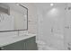 Modern bathroom featuring glass enclosed shower and vanity with dark green cabinets at 810 Maple Berry Ln # 105, Raleigh, NC 27607