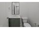 Modern half bathroom with vanity, toilet, and mirror at 810 Maple Berry Ln # 105, Raleigh, NC 27607