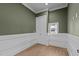 Cozy bedroom with paneled walls, hardwood flooring, a closet, and a window overlooking the outdoors at 810 Maple Berry Ln # 105, Raleigh, NC 27607