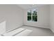 Bright bedroom featuring neutral walls, carpet and a large window at 810 Maple Berry Ln # 105, Raleigh, NC 27607