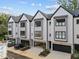Attractive townhome exterior with well-manicured landscaping and individual garages at 810 Maple Berry Ln # 105, Raleigh, NC 27607