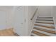 Bright hallway with wood stairs, white risers, and elevator entrance at 810 Maple Berry Ln # 105, Raleigh, NC 27607