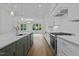 Modern kitchen featuring stainless appliances, custom cabinets and a large center island with counter seating at 810 Maple Berry Ln # 105, Raleigh, NC 27607