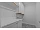 Laundry room with white cabinets, countertop, and modern finishes at 810 Maple Berry Ln # 105, Raleigh, NC 27607