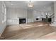 Open-concept living area featuring a fireplace, built-in cabinets, and seamless flow into the modern kitchen at 810 Maple Berry Ln # 105, Raleigh, NC 27607