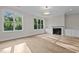 Bright living room with a fireplace, built-in cabinets, and large windows offering scenic outdoor views at 810 Maple Berry Ln # 105, Raleigh, NC 27607