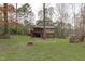 Spacious backyard featuring lush greenery, mature trees, and outdoor seating area at 900 Stoneybrook Dr, Sanford, NC 27330