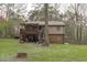 Large backyard with lush greenery and a back porch at 900 Stoneybrook Dr, Sanford, NC 27330