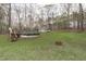 Wide shot of backyard featuring a pool, a shed, a fire pit, and surrounded by wooded area at 900 Stoneybrook Dr, Sanford, NC 27330