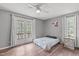 Bright bedroom with hardwood floors, ceiling fan and double doors to the outside porch at 900 Stoneybrook Dr, Sanford, NC 27330
