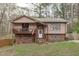 Charming two-story home featuring a cozy front porch, brick accents, and landscaped yard at 900 Stoneybrook Dr, Sanford, NC 27330