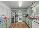Functional kitchen with stainless steel appliances and ample counter space and neutral flooring at 900 Stoneybrook Dr, Sanford, NC 27330