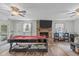 Bright living room with a fireplace, pool table, and bar area for entertaining guests at 900 Stoneybrook Dr, Sanford, NC 27330