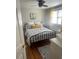 Bright bedroom featuring a bed with patterned linens and hardwood floors at 907 St Marys St, Raleigh, NC 27605