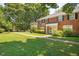 Two story red brick building with manicured lawn and mature trees at 907 St Marys St, Raleigh, NC 27605