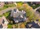 Stunning aerial view of a grand home with manicured lawns and multiple decks, showcasing its impressive architecture at 9320 Teton Pines Way, Raleigh, NC 27617