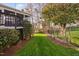 Lush, green backyard with manicured lawn, mature trees and fence, offering a private and serene outdoor space at 9320 Teton Pines Way, Raleigh, NC 27617
