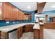 Finished basement bar area with wooden cabinetry, tile countertops, and a built-in microwave at 9320 Teton Pines Way, Raleigh, NC 27617