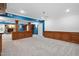 Finished basement area with wainscoting, custom wood accents, fireplace and neutral carpet at 9320 Teton Pines Way, Raleigh, NC 27617