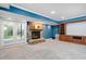 Finished basement with stone fireplace, built-in shelving, and access to the outdoor patio at 9320 Teton Pines Way, Raleigh, NC 27617