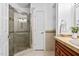 Bathroom featuring a glass shower enclosure with tile surround, stone vanity top, and neutral colors at 9320 Teton Pines Way, Raleigh, NC 27617