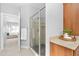 Bathroom showcasing glass shower, granite countertop, and doorway to bedroom at 9320 Teton Pines Way, Raleigh, NC 27617