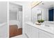 Bright bathroom with double vanity sinks, a large mirror, and entry to the bedroom at 9320 Teton Pines Way, Raleigh, NC 27617