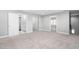 Large bedroom featuring neutral carpet, neutral paint, and multiple entry points at 9320 Teton Pines Way, Raleigh, NC 27617