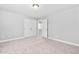 Spacious bedroom with neutral walls and carpet, includes a double door closet and additional entryway at 9320 Teton Pines Way, Raleigh, NC 27617